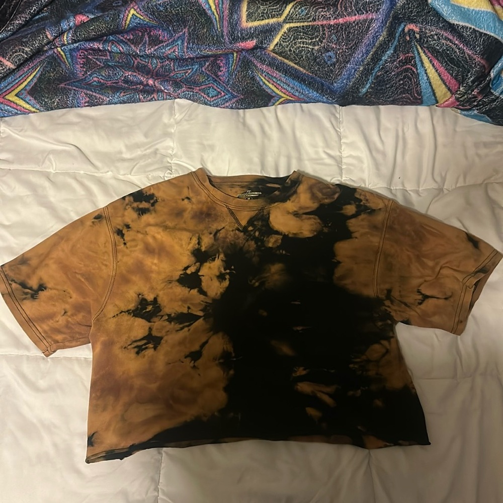 A cropped and tie-dyed black t-shirt.